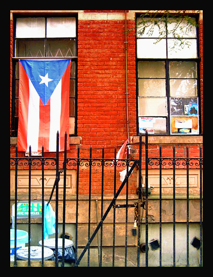 A Puerto Rican flag hanging in an East Harlem apartment window (Flickr/Richard Alexander Caraballo)